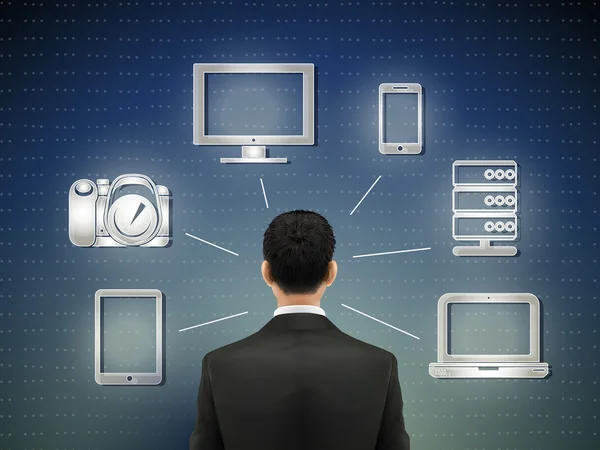 Homme d'affaires se tient devant des icônes multimédia — Image vectorielle