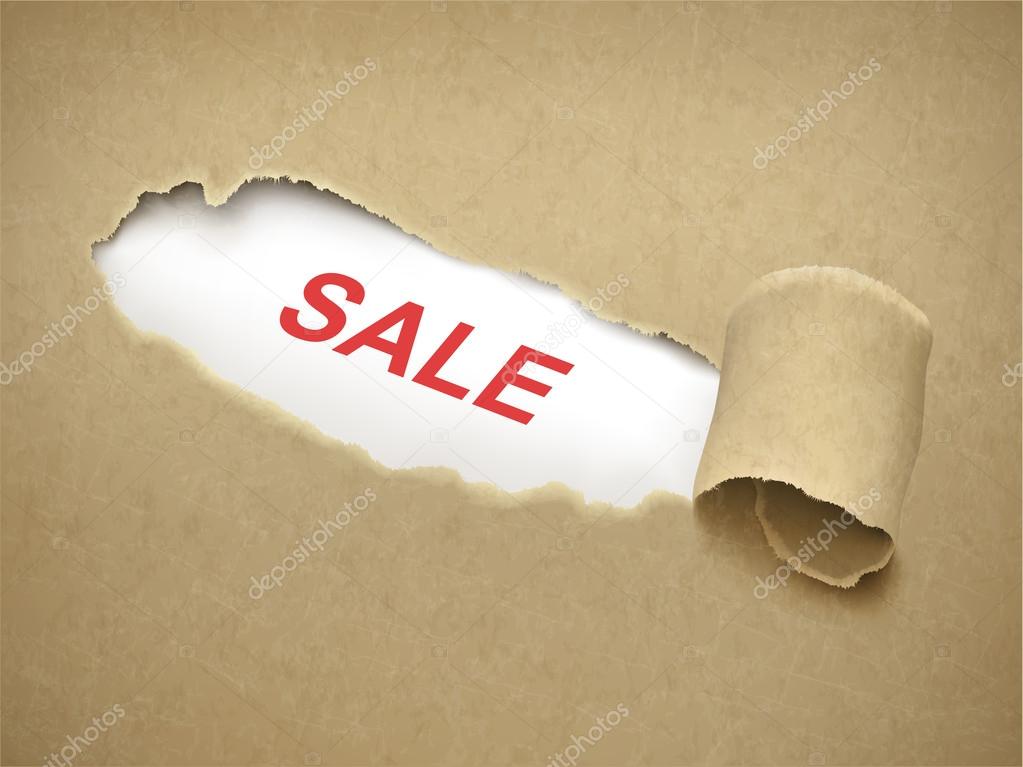 Paper torn to reveal word sale