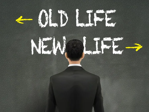 Forretningsmand ser på gamle og nye liv ord – Stock-vektor