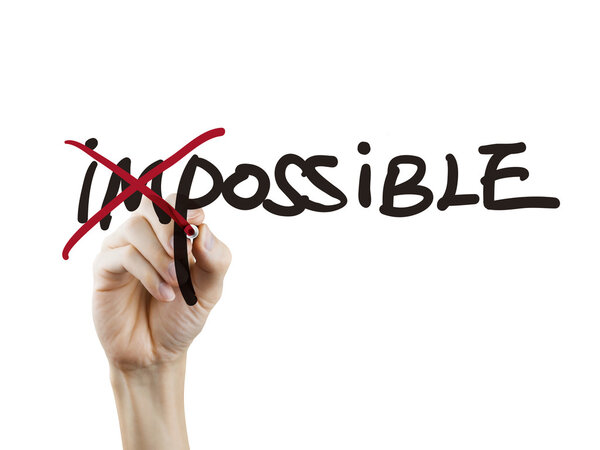 hand turning the word impossible into possible 