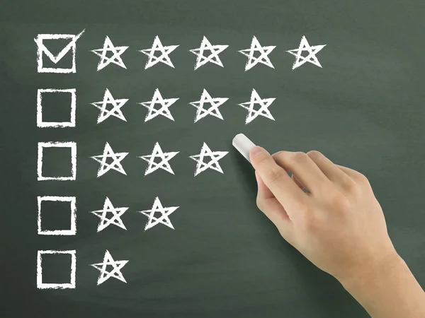 Hand putting check mark with chalk — Stock Photo, Image