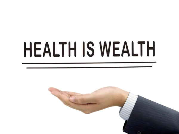 Health is wealth words holding by businessman 's hand — стоковое фото