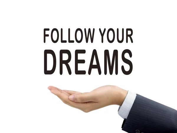 Follow your dreams words holding by businessman 's hand — стоковое фото