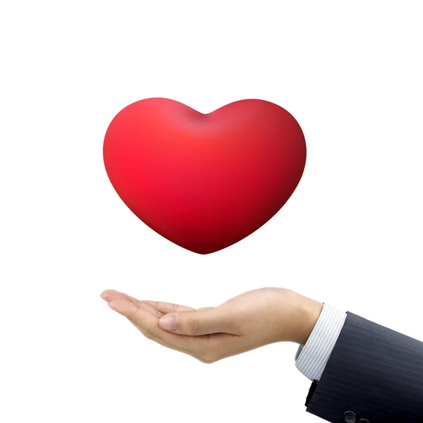 Mano dell'uomo d'affari che tiene il simbolo rosso del cuore — Foto Stock