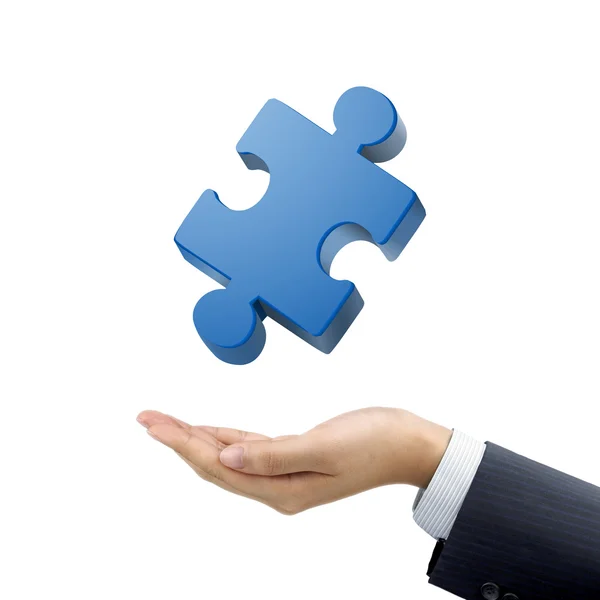 Businessman's hand holding jigsaw puzzle piece — Stock Photo, Image