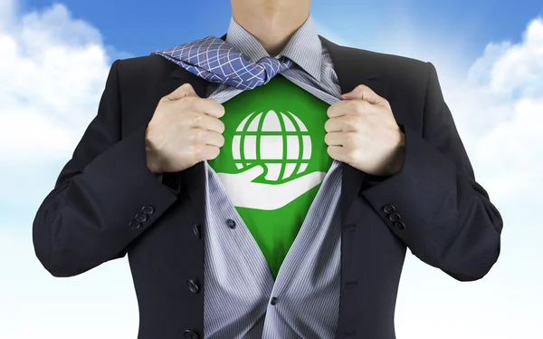 Businessman showing earth icon underneath his shirt — Stock Photo, Image