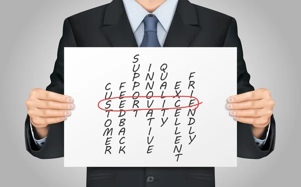 Businessman holding service crossword poster — Stock Vector