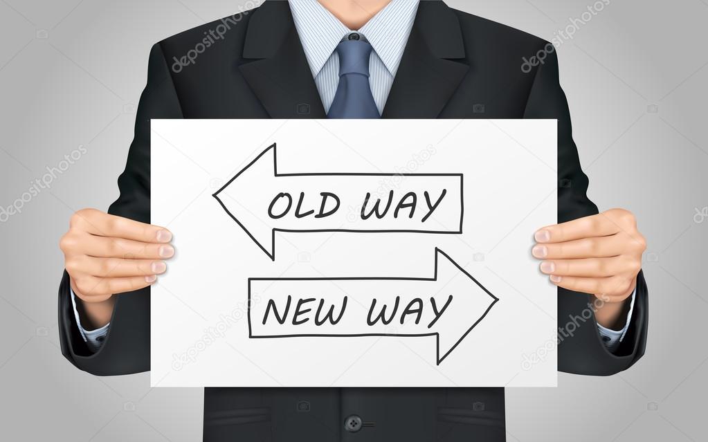 businessman holding old way or new way poster