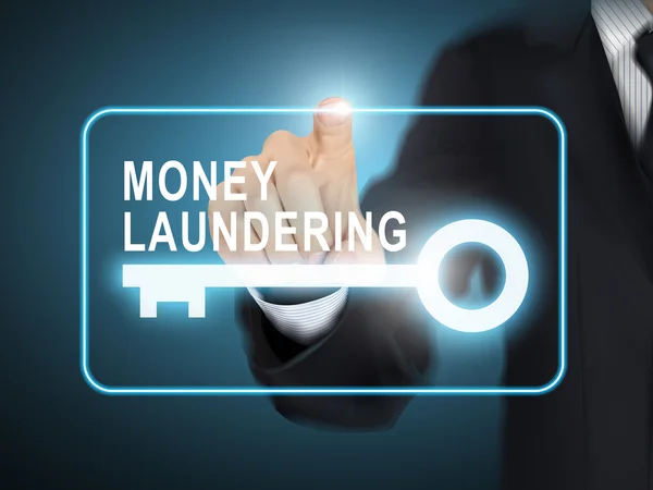 Mannenhand op sleutelknop naast witwassen van geld te drukken — Stockvector