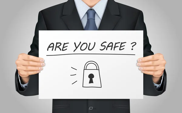 Homem de negócios segurando você está seguro cartaz —  Vetores de Stock