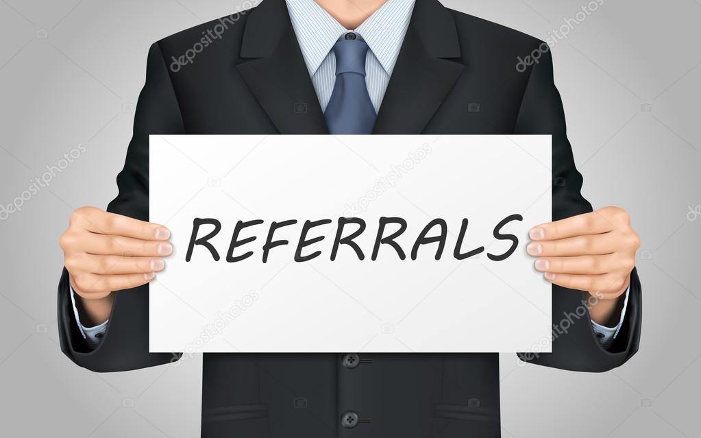 businessman holding referrals word poster