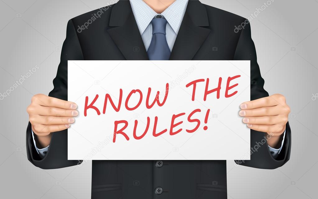 businessman holding know the rules poster