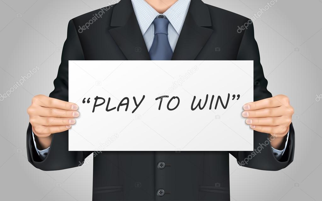 businessman holding play to win poster