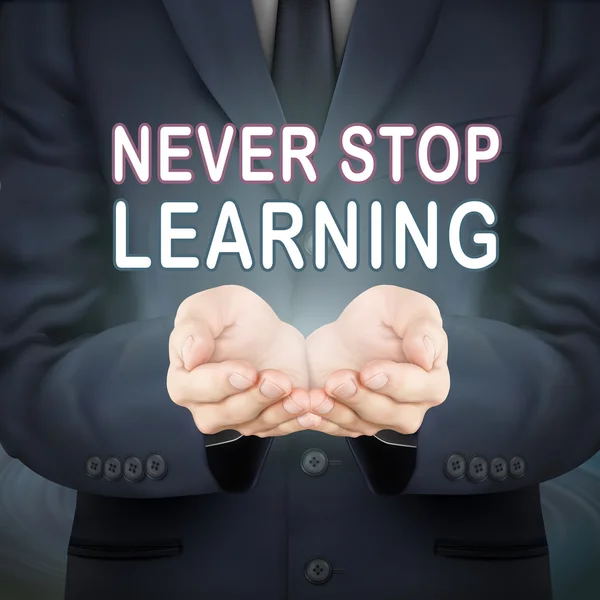 Business man holding never stop learning words — стоковый вектор