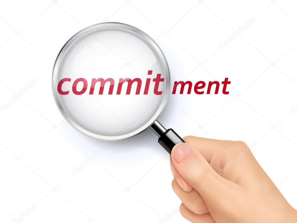 commitment word showing through magnifying glass