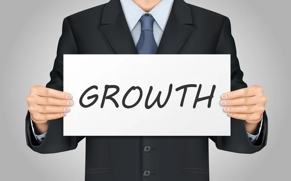 Empresário segurando cartaz de crescimento — Vetor de Stock