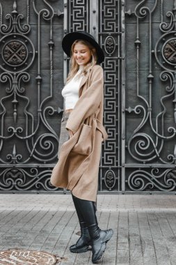 Kahverengi ceketli, siyah şapkalı, gülümseyen, üzgün