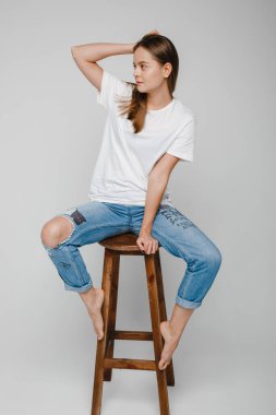 Model testleri. Sandalyeye oturup poz veren uzun saçlı güzel kız.