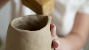 Kadın seramikçi elleri kil tabakları yontuyor