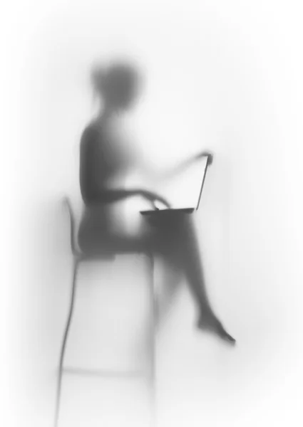 Silhouette, slim woman sits with laptop computer — Stock Photo, Image