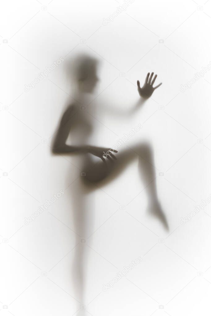 Beautiful slim woman body diffuse, blurry silhouette, sharp hands and fingers. 