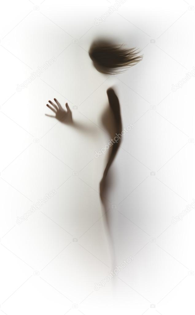 Human female silhouette behind a glass surface
