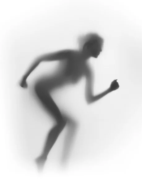Diffuse Silhouette einer Läuferin — Stockfoto