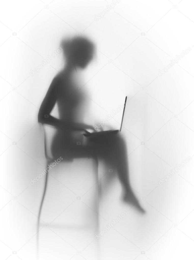 Silhouette of a pretty, slim woman with laptop and chair
