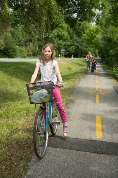 Beautiful young girl with bicycle outdoor — Stockfoto