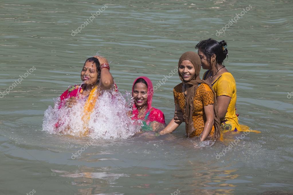 Indian Woman Wash Themselves In The River Ganges In The Holy City Of