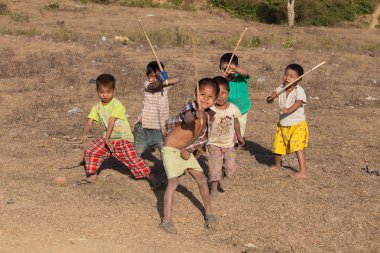 Burmese children are playing near the Buddhist stupa. Mrauk U, Myanmar clipart