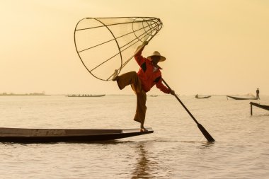 Birman balıkçı bambu teknede el yapımı net ile geleneksel şekilde balık yakalamak. Inle Gölü, Myanmar, Burma