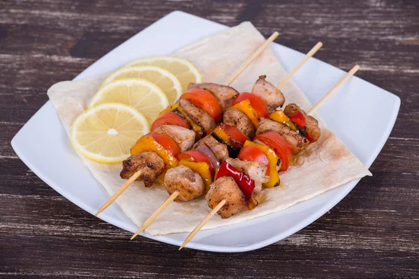 Tasty grilled meat and vegetables on skewer — Stock Photo, Image