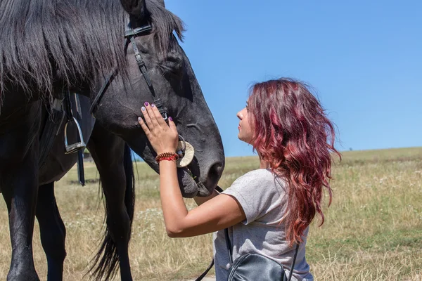 Beautiful girl and black horse in nature. Kiev, Ukraine — Stock Photo, Image
