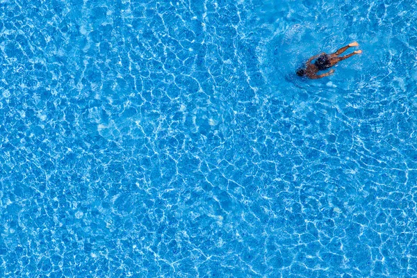 Um homem nada na piscina do hotel. Vista de cima . — Fotografia de Stock