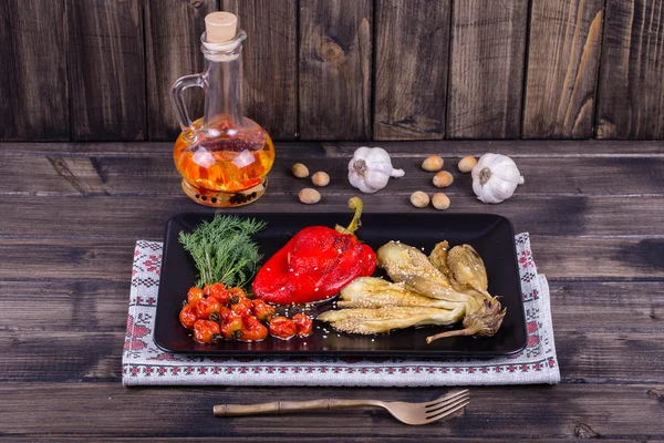 Roasted vegetables in black plate