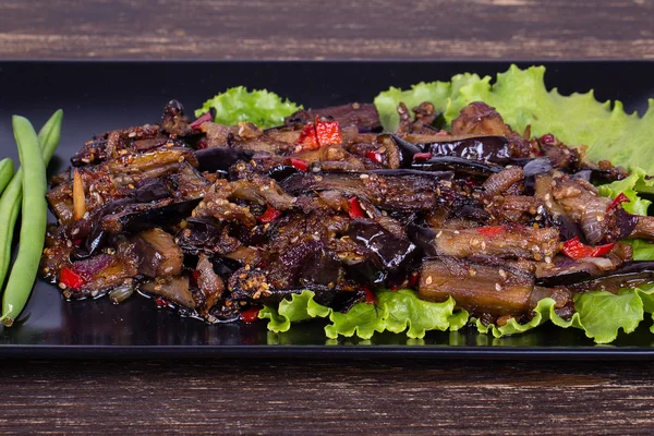 Baked eggplant with onions, garlic, red hot chili pepper and walnuts — Stock Photo, Image