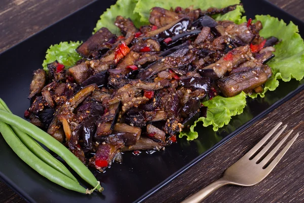 Baked eggplant with onions, garlic, red hot chili pepper and walnuts — Stock Photo, Image