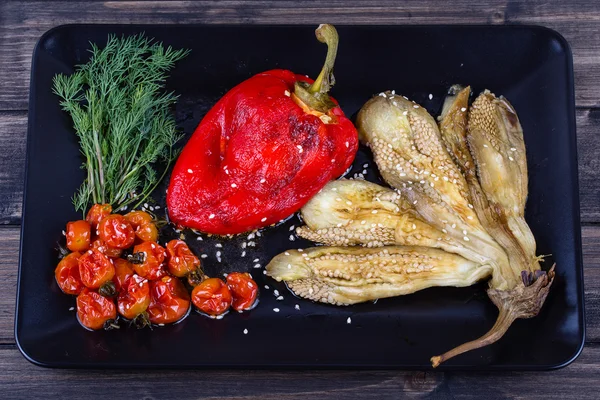 Roasted vegetables in black plate — Stock Photo, Image