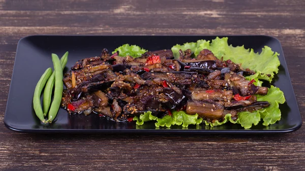 Baked eggplant with onions, garlic, red hot chili pepper and walnuts — Stock Photo, Image