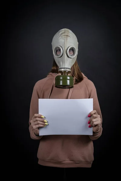 Girl Gas Mask Black Background Holds White Sheet Close Your — Stock Photo, Image