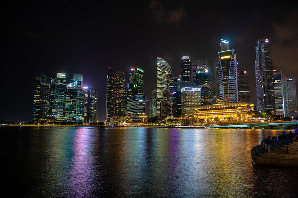 SINGAPORE CITY, SINGAPORE - MARCH 29, 2019: Singapore Skyline and view of skyscrapers on Marina Bay at night . Singapore cityscape of the financial district