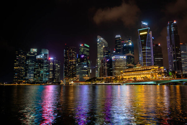 SINGAPORE CITY, SINGAPORE - MARCH 29, 2019: Singapore Skyline and view of skyscrapers on Marina Bay at night . Singapore cityscape of the financial district