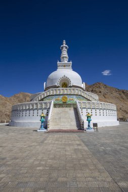 White buddhist stupa or pagoda in tibetan monastery near village Leh in ladakh region, noth India clipart