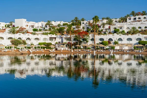 Edificios Tumbonas Sombrillas Palmeras Reflejan Calma Del Agua Del Mar —  Fotos de Stock