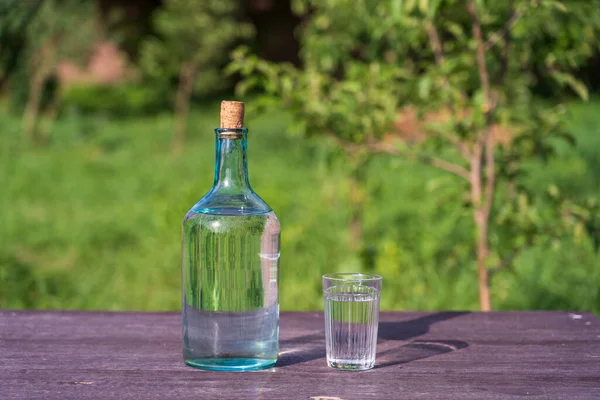 Glass Big Bottle Drinking Water Wooden Table Nature Background Garden — Stock Photo, Image