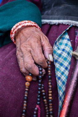 Hemis Manastırı, Ladakh, Jammu ve Kashmir Eyaleti 'nde Budist tespihi tutan yaşlı Tibetli kadın. El ve tespih, kapat.