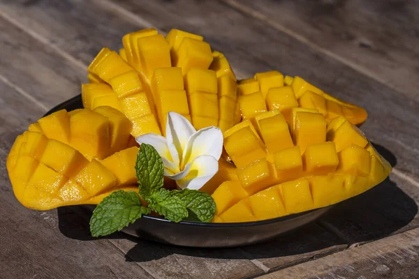 Fresh organic mango slices on wooden table, close up. Thailand