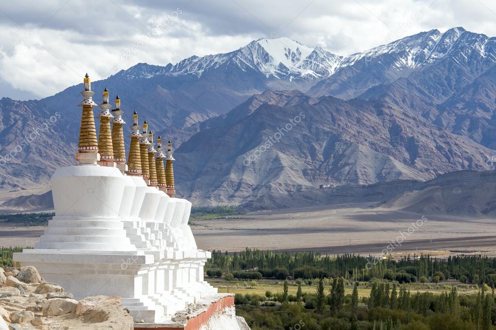 Buddhist chortens (stupa) and Himalayas mountains in the background near Shey Palace in Ladakh, India 