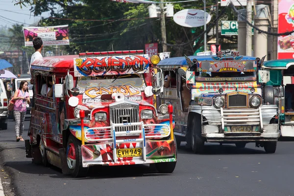Jeepneys passing, Filipino inexpensive bus service. — Stock Photo, Image
